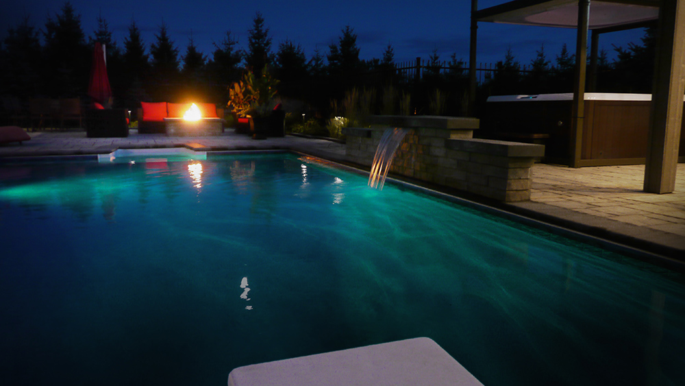 Pool water feature at night in Ottawa